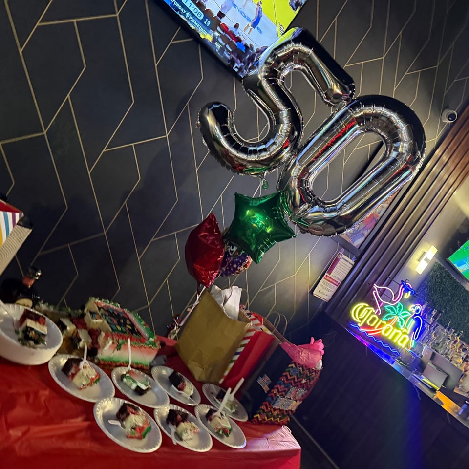 Birthday celebration with balloons, cake slices, and a festive table setup at the restaurant.